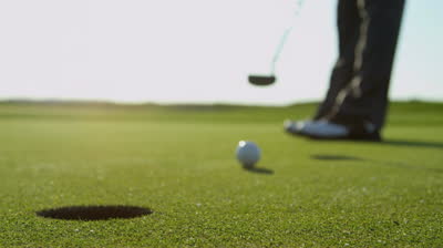 stock-footage-close-up-legs-feet-male-professional-golfer-using-putter-to-hole-the-ball-slow-motion-shot-on-red